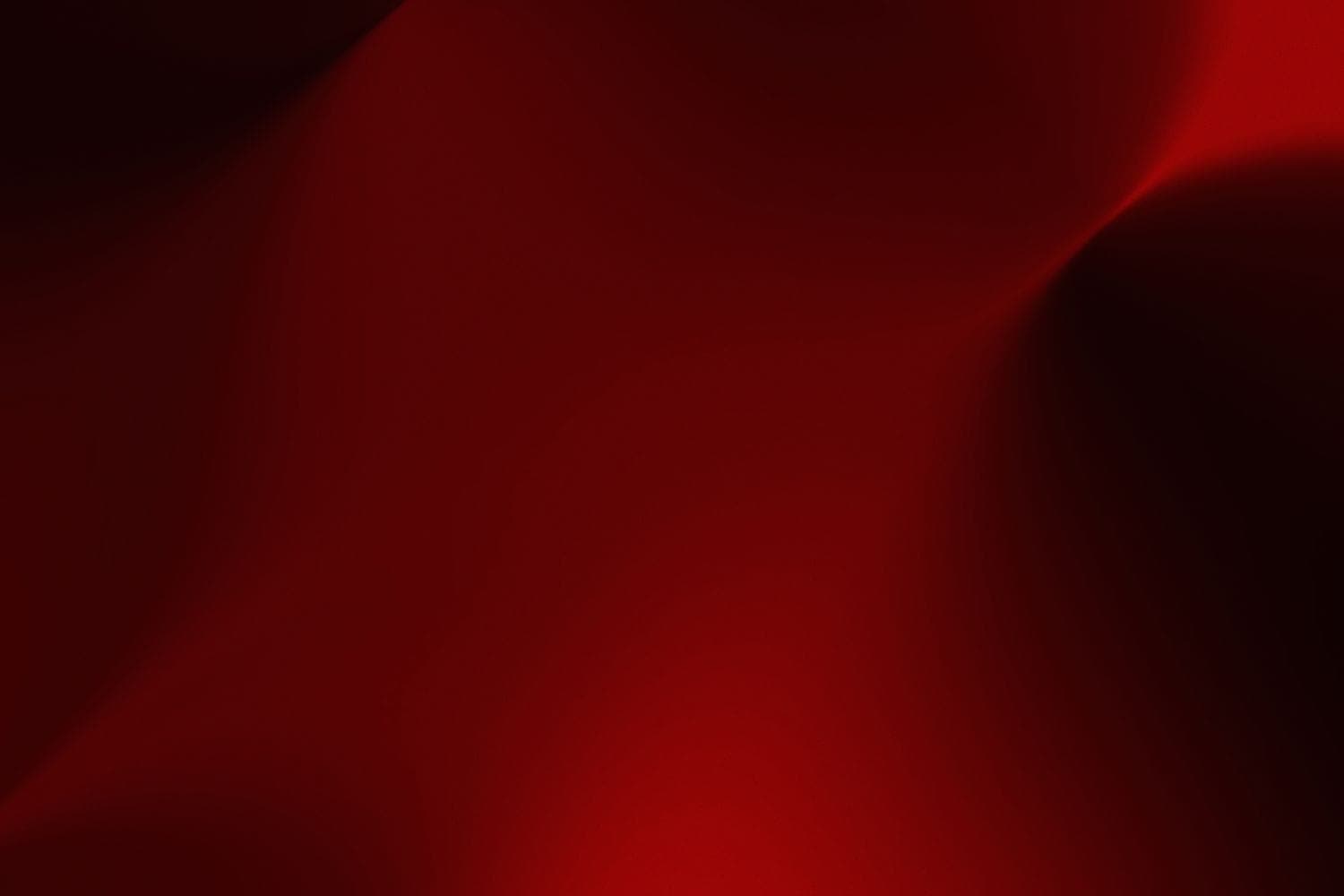 Abstract study in deep red: a smooth surface folding into shadow.